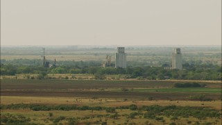 HDA12_098 - HD stock footage aerial video of silos and farmland in Temple, Oklahoma