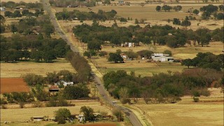 HDA12_108 - HD stock footage aerial video of a country road and farms in Temple, Oklahoma
