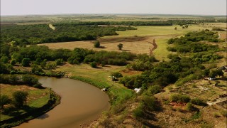 HDA12_112 - HD stock footage aerial video of a reverse view of farms, reveal a river in Oklahoma