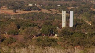 HDA12_123 - HD stock footage aerial video of tall silos, rural homes and trees in Meridian, Oklahoma