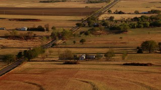 HDA12_128 - HD stock footage aerial video of farms and a country road at sunset in Meridian, Oklahoma