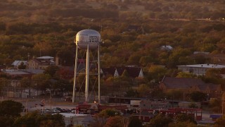 HDA12_151 - HD stock footage aerial video of a water tower and small town at sunset, Nocona, Texas