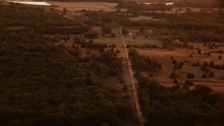 HDA12_157 - HD stock footage aerial video of a home and power lines at sunset in Texas