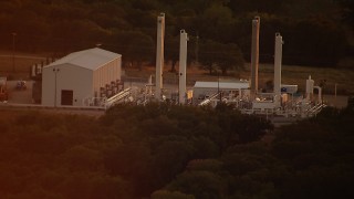 HDA12_158 - HD stock footage aerial video of an industrial building at sunset in Texas