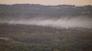 HDA12_163 - HD stock footage aerial video of thick smoke rising from trees at sunset in Texas