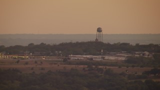 HDA12_171 - HD stock footage aerial video of a water tower at sunset in a small town, Decatur, Texas