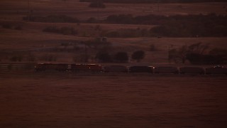 HDA12_180 - HD stock footage aerial video of a train passing through countryside at night in Decatur, Texas