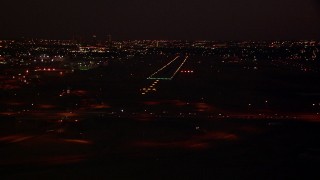 HDA12_186 - HD stock footage aerial video approach the Fort Worth Meacham International Airport runway at night, Texas