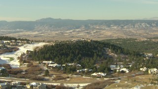 HDA13_279 - HD stock footage aerial video of flying over homes and a hilltop mansion in Castle Pines, Colorado
