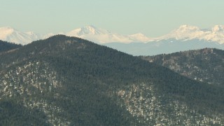 HDA13_302 - HD stock footage aerial video of mountains with trees and light snow in the Rocky Mountains, Colorado