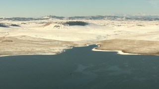 HDA13_312 - HD stock footage aerial video fly over a lake toward the opposite, snowy shore in Park County, Colorado