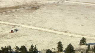 HDA13_321 - HD stock footage aerial video tilt to reveal barn and ranch house by a country road in Park County, Colorado