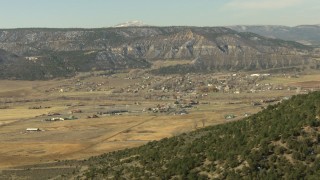 HDA13_345_03 - HD stock footage aerial video pan across a mountain ridge to reveal the small town of Ridgway, Colorado