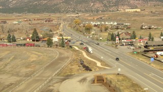 HDA13_346 - HD stock footage aerial video of flying over highway to land next to hotel in Ridgway, Colorado