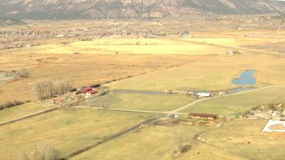 HDA13_349 - HD stock footage aerial video fly over river and farms toward the small town of Ridgway, Colorado