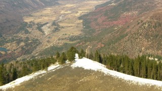HDA13_379 - HD stock footage aerial video fly over mountain ridge toward rural valley in the Rocky Mountains, Colorado
