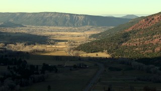 HDA13_392_01 - HD stock footage aerial video of following the road toward the town of Ridgway, Colorado at sunset