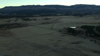 HDA13_397 - HD stock footage aerial video of flying over open fields at sunrise, Ridgway, Colorado