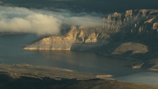 HDA13_415_01 - HD stock footage aerial video of low clouds over the Blue Mesa Reservoir at sunrise, Colorado