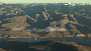 HDA13_416 - HD stock footage aerial video of flying by the Blue Mesa Reservoir and Rocky Mountains at sunrise, Colorado