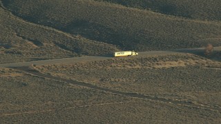 HDA13_418 - HD stock footage aerial video of a big rig on Highway 50 at sunrise, Blue Mesa Reservoir, Colorado