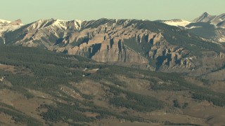 HDA13_429 - HD aerial stock footage video of rolling hills near steep slopes of the Rocky Mountains at sunrise, Colorado