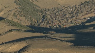 HDA13_436 - HD stock footage aerial video of rural homes and trees at sunrise in Colorado