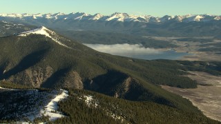 HDA13_440_03 - HD stock footage aerial video of panning across the mountains at sunrise and reveal reservoir, Rocky Mountains, Colorado