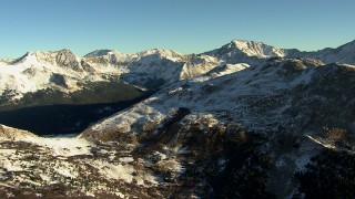 HDA13_446 - HD stock footage aerial video of flying by the Rocky Mountains with snow at sunrise, Colorado