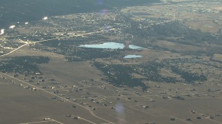 HDA13_451 - HD stock footage aerial video of the town of Buena Vista and lakes at sunrise, Colorado