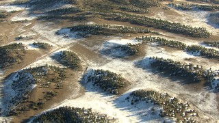 HDA13_468 - HD stock footage aerial video of flying over rounded hills and patches of snow in Park County, Colorado