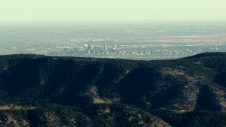 HDA13_480 - HD stock footage aerial video of the Denver skyline seen from a green ridge in the Rocky Mountains, Colorado
