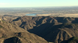 HDA13_482_04 - HD stock footage aerial video of reservoirs and the Rocky Mountains, zoom tighter on Downtown Denver, Colorado