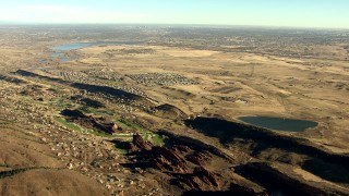 HDA13_483_01 - HD stock footage aerial video of Roxborough Park and reservoirs, zoom tighter on Downtown Denver skyline, Colorado