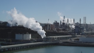 JDC01_022 - 5K aerial stock footage of ConocoPhillips Oil Refinery, steam rising, shore of San Pablo Bay, Rodeo, California