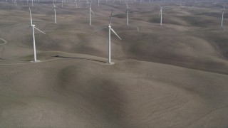 JDC01_063 - 5K stock footage aerial video tilt from small hills, reveal Shiloh Wind Power Plant windmills, Montezuma Hills, California