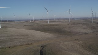 JDC01_065 - 5K stock footage aerial video tilt from hills to reveal Shiloh Wind Power Plant windmills, Montezuma Hills, California