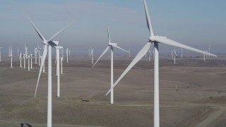 JDC01_074 - 5K aerial stock footage of flying by a row of windmills, Shiloh Wind Power Plant, Montezuma Hills, California