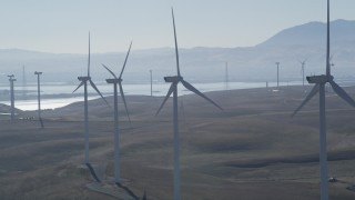 JDC01_075 - 5K stock footage aerial video of flying by a row of windmills, Shiloh Wind Power Plant, Montezuma Hills, California
