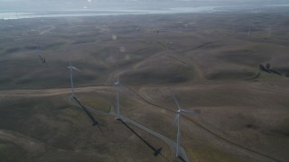 JDC01_077 - 5K aerial stock footage of flying by a row of windmills, Shiloh Wind Power Plant, Montezuma Hills, California