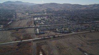 JDC01_083 - 5K aerial stock footage of approaching a train passing suburban houses, Pittsburg, California