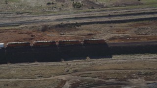 JDC01_087 - 5K aerial stock footage of tracking the engines of a train as it moves past fields, Pittsburg, California