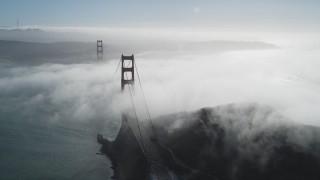 JDC02_019 - 5K stock footage aerial video of flying by thick fog rolling over the historic Golden Gate Bridge, San Francisco, California