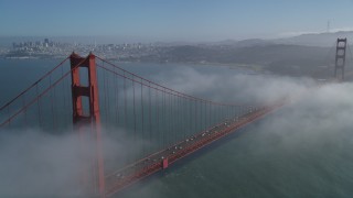 JDC02_025 - 5K stock footage aerial video fly over Marin Hills, reveal famous and iconic Golden Gate Bridge in fog, San Francisco, California
