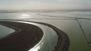JDC03_010 - 5K aerial stock footage of flying over marshland, pan across sloughs and power lines, Sunnyvale, California