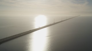 JDC04_040 - 5K aerial stock footage of flying by San Mateo Bridge, sun reflecting off San Francisco Bay, California