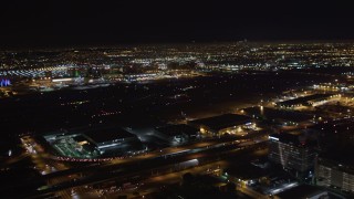 LD01_0006 - 5K aerial stock footage track a passenger jet landing at night, LAX (Los Angeles International Airport), California