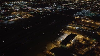LD01_0007 - 5K aerial stock footage track a jet landing at night, LAX (Los Angeles International Airport), California