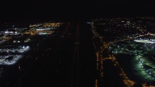 LD01_0017 - 5K aerial stock footage of a jet on the runway at LAX (Los Angeles International Airport), California at night