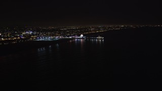 LD01_0038 - 5K aerial stock footage an approach to Santa Monica Pier, California at night